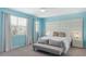 Serene bedroom with light blue walls, soft curtains, and tufted headboard at 9004 Sunshine Ridge Loop, Kissimmee, FL 34747