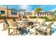 Community outdoor fire pit surrounded by Adirondack chairs in a lush green space at 9004 Sunshine Ridge Loop, Kissimmee, FL 34747