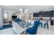 Open-concept dining area with modern light fixture, seating for eight, and cohesive design elements at 9004 Sunshine Ridge Loop, Kissimmee, FL 34747