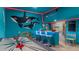 Fun themed game room with air hockey, bar and shark wall art for entertainment at 9004 Sunshine Ridge Loop, Kissimmee, FL 34747