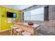 Entertaining game room features a custom bar area, brick accent wall and fun string lights at 9004 Sunshine Ridge Loop, Kissimmee, FL 34747