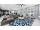 Bright living room featuring a modern ceiling fan, stylish furniture, and sliding glass doors at 9004 Sunshine Ridge Loop, Kissimmee, FL 34747