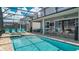 Screened-in pool area with a spa, comfortable seating and an outdoor entertaining space at 9004 Sunshine Ridge Loop, Kissimmee, FL 34747