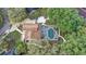 Aerial view of a home featuring a screened-in pool, lush landscaping, and a patio at 1204 Swan St, Winter Springs, FL 32708