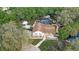 Aerial view of a home featuring a screened-in pool, outbuildings, and mature trees at 1204 Swan St, Winter Springs, FL 32708