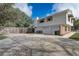 Spacious backyard featuring a two-car garage, ample parking space, and a private fence at 1204 Swan St, Winter Springs, FL 32708