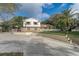 Charming two-story home featuring palm trees, brick accents, and a spacious driveway on a sunny day at 1204 Swan St, Winter Springs, FL 32708