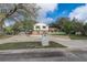 View of home and driveway, showcasing the two-story design with brick accents and mature trees at 1204 Swan St, Winter Springs, FL 32708