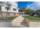 Inviting home entrance with walkway steps leading to a cozy front porch and white picket fence at 1204 Swan St, Winter Springs, FL 32708