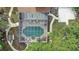 Aerial view of a screened-in pool with outdoor seating surrounded by trees at 1204 Swan St, Winter Springs, FL 32708