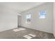 Bright bedroom with neutral walls, carpet, and two windows with an exterior view at 2581 Runners Cir, Clermont, FL 34714