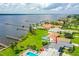 Stunning waterfront property with a pool, lush lawn, and a private dock, offering picturesque views of the water at 3168 S Peninsula Dr, Daytona Beach, FL 32118