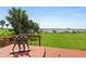 Charming back porch with an artful statue overlooking a lush lawn and tranquil waters, creating a serene outdoor retreat at 3168 S Peninsula Dr, Daytona Beach, FL 32118