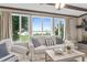 Bright living room featuring large windows with water views, comfortable seating, and elegant decor at 3168 S Peninsula Dr, Daytona Beach, FL 32118