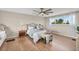 Serene main bedroom with wood floors, a ceiling fan, and a sunlit window, creating a relaxing retreat at 3168 S Peninsula Dr, Daytona Beach, FL 32118