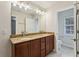 Bathroom features a double sink vanity with granite countertop and a separate toilet room at 8639 Lower Villagewalk Cir, Orlando, FL 32827