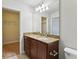 Cozy bathroom with granite countertops on vanity and views of multiple walk-in closets at 8639 Lower Villagewalk Cir, Orlando, FL 32827