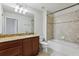 Bathroom featuring vanity with granite counters and a shower-tub combination with decorative tile at 8639 Lower Villagewalk Cir, Orlando, FL 32827