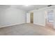 Bright bedroom boasts neutral paint, plush carpeting, and access to a walk-in closet at 8639 Lower Villagewalk Cir, Orlando, FL 32827