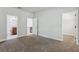 Neutral bedroom has multiple doors that lead into the bathroom and closet at 8639 Lower Villagewalk Cir, Orlando, FL 32827