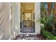 Inviting covered entryway with decorative gate and brick pavers for enhanced curb appeal at 8639 Lower Villagewalk Cir, Orlando, FL 32827