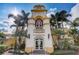 Exterior shot of the Town Center with palm trees at 8639 Lower Villagewalk Cir, Orlando, FL 32827