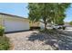 Paver driveway leading to a two-car garage with mature landscaping and shade trees at 8639 Lower Villagewalk Cir, Orlando, FL 32827