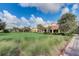 Exterior shot of clubhouse featuring lush landscaping and well-manicured lawn at 8639 Lower Villagewalk Cir, Orlando, FL 32827