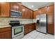 Modern kitchen features stainless steel appliances, granite counters, and ample cabinet storage at 8639 Lower Villagewalk Cir, Orlando, FL 32827