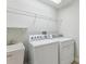 Well-equipped laundry room featuring a utility sink, modern appliances, and ample shelving at 8639 Lower Villagewalk Cir, Orlando, FL 32827