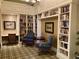 Cozy library with extensive bookshelves, comfortable chairs, and natural light for reading at 8639 Lower Villagewalk Cir, Orlando, FL 32827