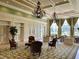 Elegant clubhouse lobby with chandeliers, decorative rugs, and seating at 8639 Lower Villagewalk Cir, Orlando, FL 32827