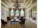 Bright lounge features large windows, elegant chandelier, fireplace, and comfortable seating for relaxation at 8639 Lower Villagewalk Cir, Orlando, FL 32827
