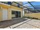 Outdoor patio area with pavers, a screened-in enclosure, and sliding glass doors at 8639 Lower Villagewalk Cir, Orlando, FL 32827
