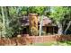 Aerial shot showcasing a wooded home with a fence and mature trees at 1 W Village Dr, Oviedo, FL 32765