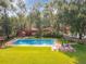Community pool and tennis courts surrounded by lush landscaping at 1 W Village Dr, Oviedo, FL 32765