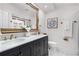 Bathroom featuring a double sink vanity, large mirror, and tile flooring at 1 W Village Dr, Oviedo, FL 32765