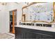 Bathroom with dual sinks and a large mirror at 1 W Village Dr, Oviedo, FL 32765