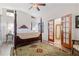 Primary bedroom showcasing a four-poster bed, a ceiling fan, and french doors at 1 W Village Dr, Oviedo, FL 32765