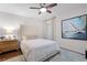 Comfortable bedroom with a tufted headboard, soft lighting, and nautical themed art at 1 W Village Dr, Oviedo, FL 32765