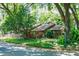Charming home nestled in a lush, green landscape with mature trees and a well-maintained front yard at 1 W Village Dr, Oviedo, FL 32765