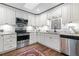 Cozy kitchen with stainless steel appliances, white cabinetry and a skylight for natural light at 1 W Village Dr, Oviedo, FL 32765
