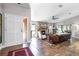 Inviting living room with fireplace, hardwood floors, and an abundance of natural light at 1 W Village Dr, Oviedo, FL 32765