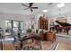 A spacious living room features a leather sofa and a doorway to the dining area with outdoor views at 1 W Village Dr, Oviedo, FL 32765