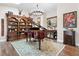 A lovely room features a grand piano and chandelier with beautiful décor and natural light at 1 W Village Dr, Oviedo, FL 32765