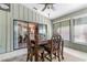 Inviting sunroom with sliding glass doors, dining table, and views of the backyard at 1 W Village Dr, Oviedo, FL 32765