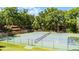 Enjoy this well-maintained tennis court, surrounded by lush greenery for a private playing experience at 1 W Village Dr, Oviedo, FL 32765