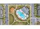 Overhead view of community amenities, including the pool and playground, surrounded by greenery at 10684 Words Dr, Winter Garden, FL 34787