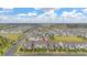 Scenic view shows manicured lawns, landscaping, and neighborhood with a blue sky and scattered clouds at 10684 Words Dr, Winter Garden, FL 34787