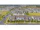 An expansive aerial view of a meticulously planned community with neatly arranged homes and well-maintained streets at 10684 Words Dr, Winter Garden, FL 34787